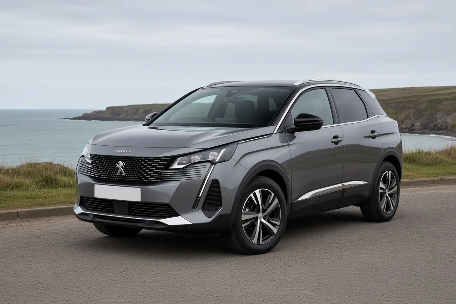 Peugeot 3008 second generation in Cumulus Grey on a British coastal road in overcast daylight, the whole SUV visible