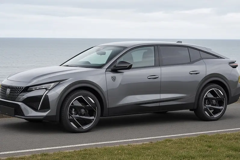 Peugeot 408 fastback in Cumulus Grey, side view on a British coastal road, the whole car visible