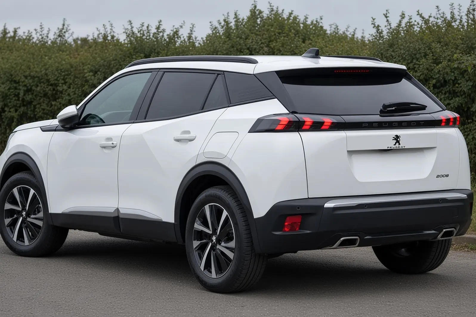 Peugeot 2008 second generation facelift in Okenite White in a British lay-by, rear three-quarter view, the whole small SUV visible