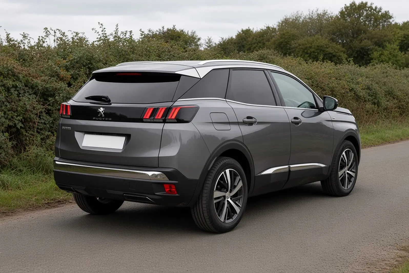 Peugeot 3008 second generation in Nimbus Grey on a British country lane, rear three-quarter view, the whole SUV visible