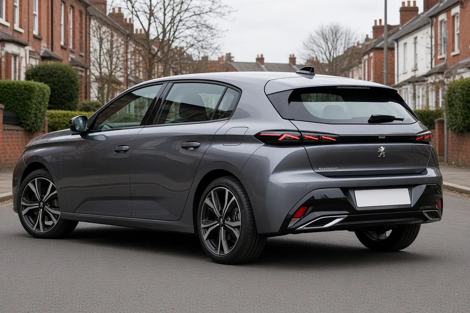 Peugeot 308 third generation in Selenium Grey on a British residential street, rear three-quarter view, the whole hatchback visible