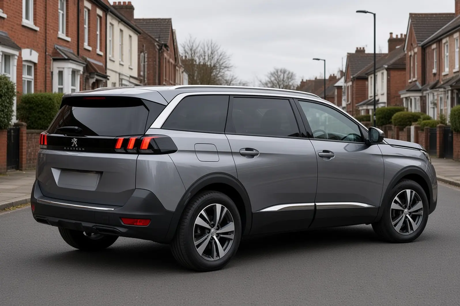 Peugeot 5008 second generation in Cumulus Grey on a British residential street, rear three-quarter view, the whole seven-seat SUV visible